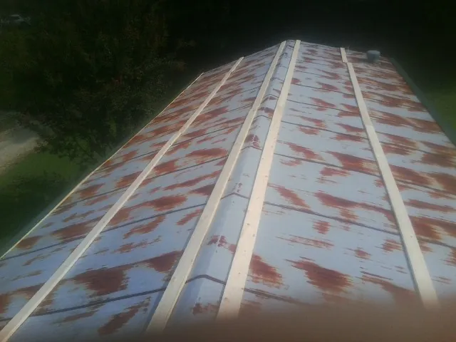 Rusted metal roof panels with new wood purlins before replacement — Storm Damage Roof Repair in Mossyrock by Roofing Brothers