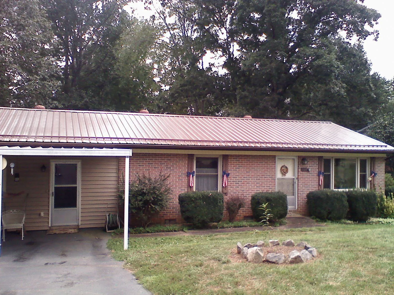 Bronze metal roof and carport on a brick ranch home — Roof Repair work by our crew in Mossyrock